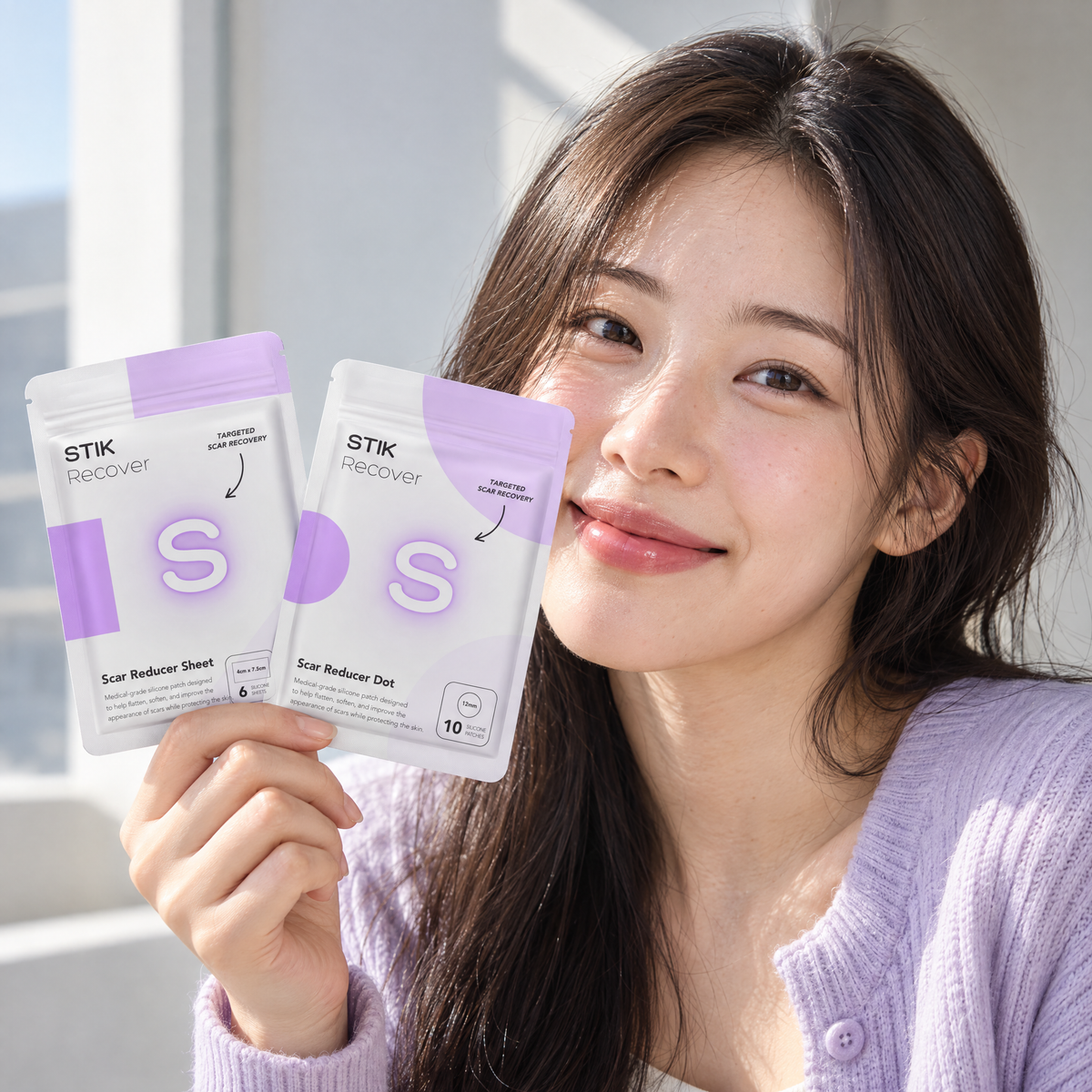 Model holding both Scar Care Kit pouches